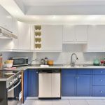 a-kitchen-with-blue-cabinets-and-a-black-refrigerator